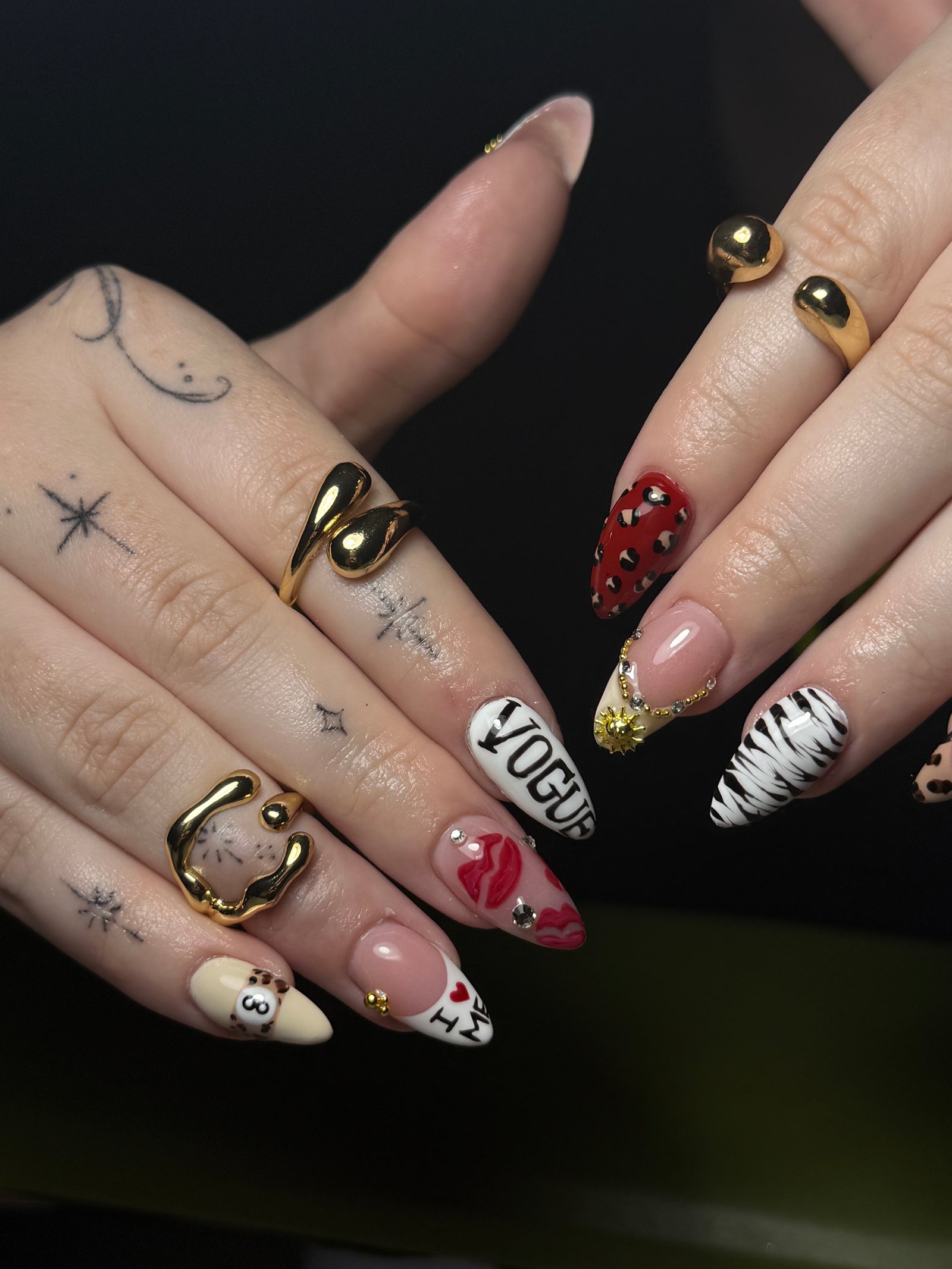 Red, gold, black, and white detailed nails by Purebeyoutybar